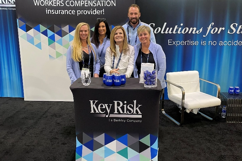 Five team members pose for a picture at day 1 of an American Staffing Association convention