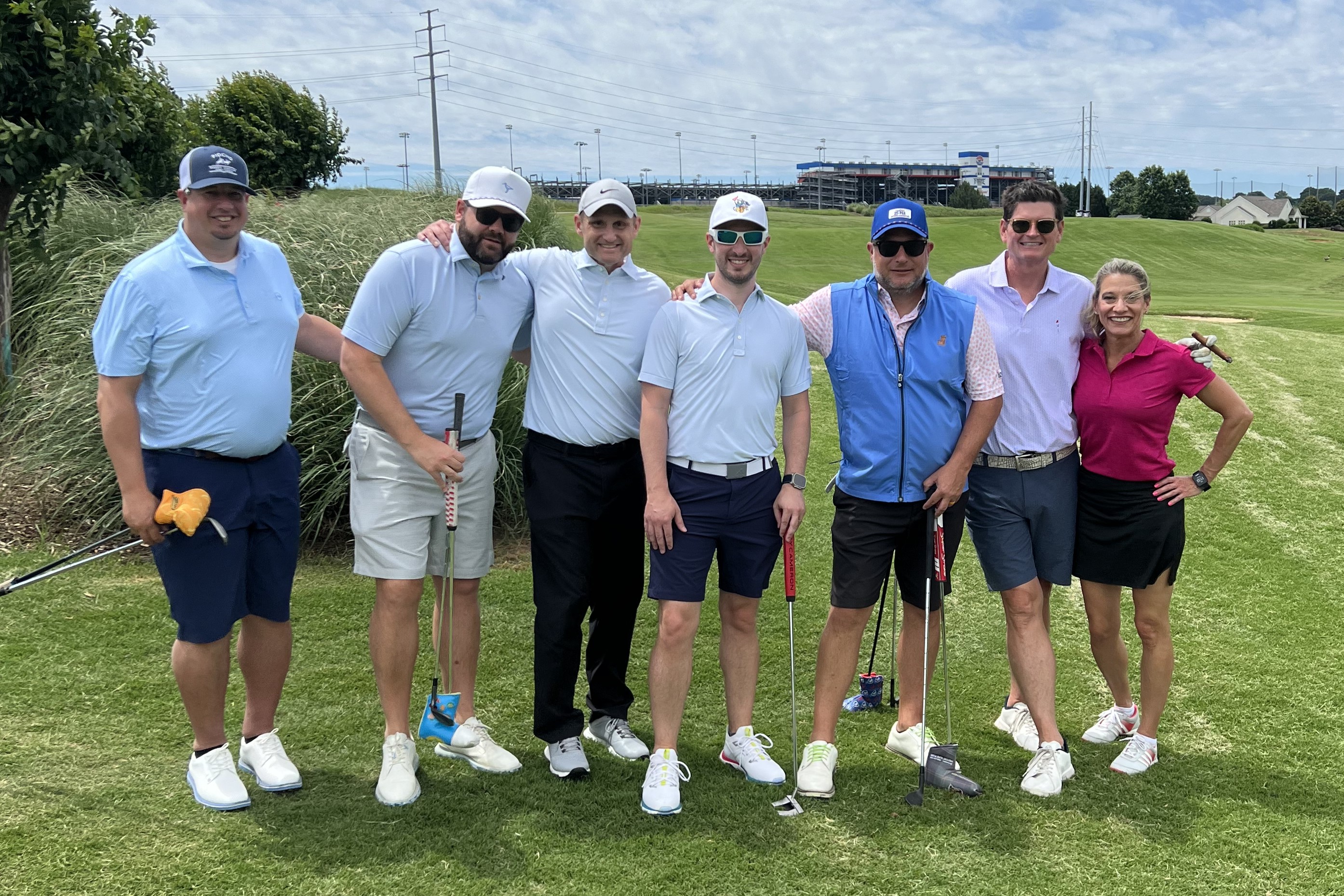 The Key Risk team smiles at the camera before they tee off