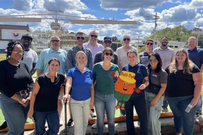 The Key Risk team poses at a putt-putt course